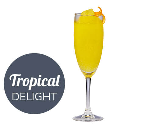 yellow cocktail with an orange peel on the rim of the glass